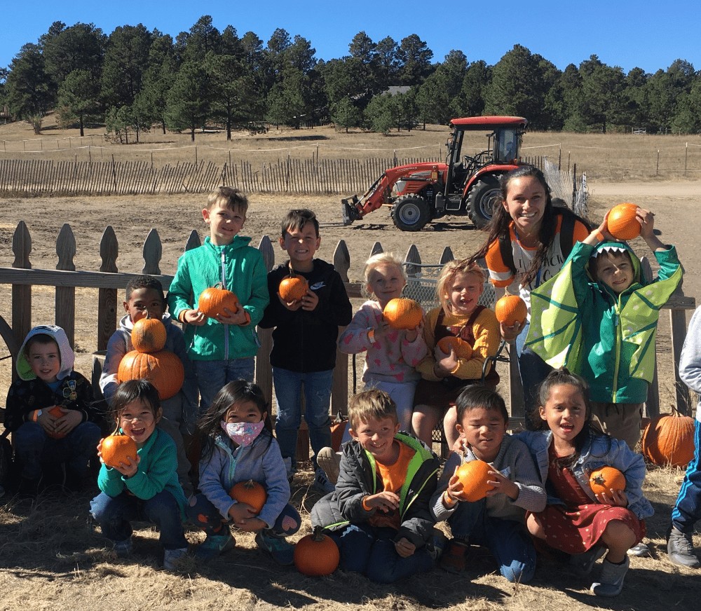 EES kindergartners at a pumpkin patch with their teacher.